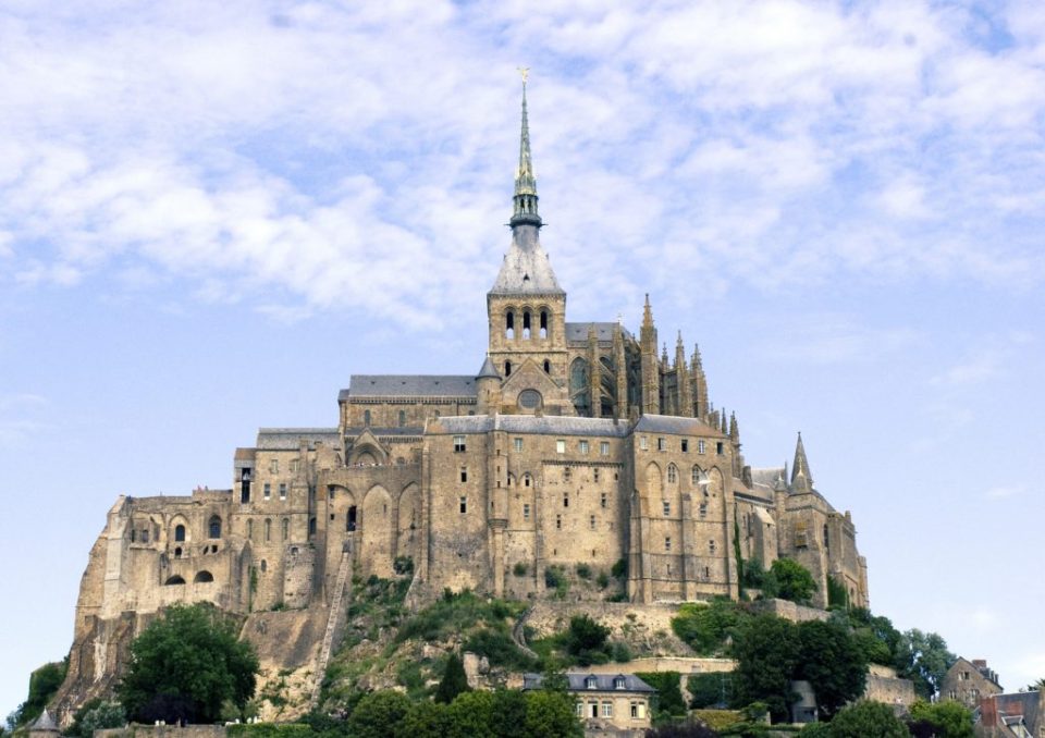 Mont-Saint-Michel-Main-1024×724 a castle with a clock tower in front of Mont Saint Michel Abbey