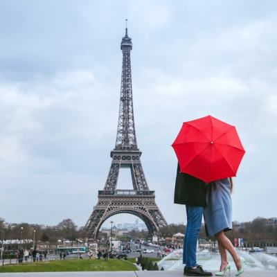 a man flying through the air while holding an umbrella