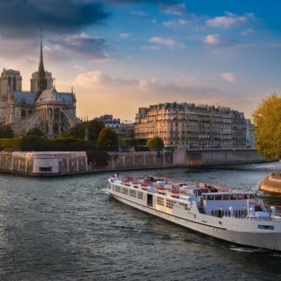 a small boat in a body of water with a city in the background