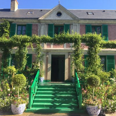 a house with bushes in front of a building