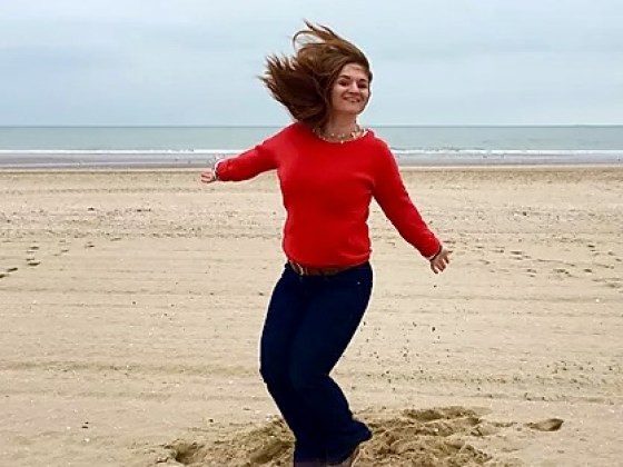 sarah a person standing on top of a sandy beach